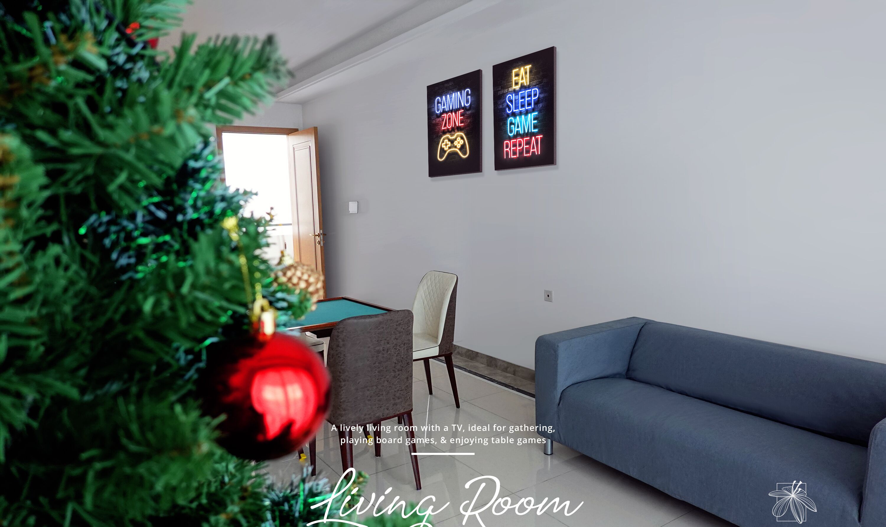 A living room with a TV, a blue sofa, a gaming zone sign, and a Christmas tree.