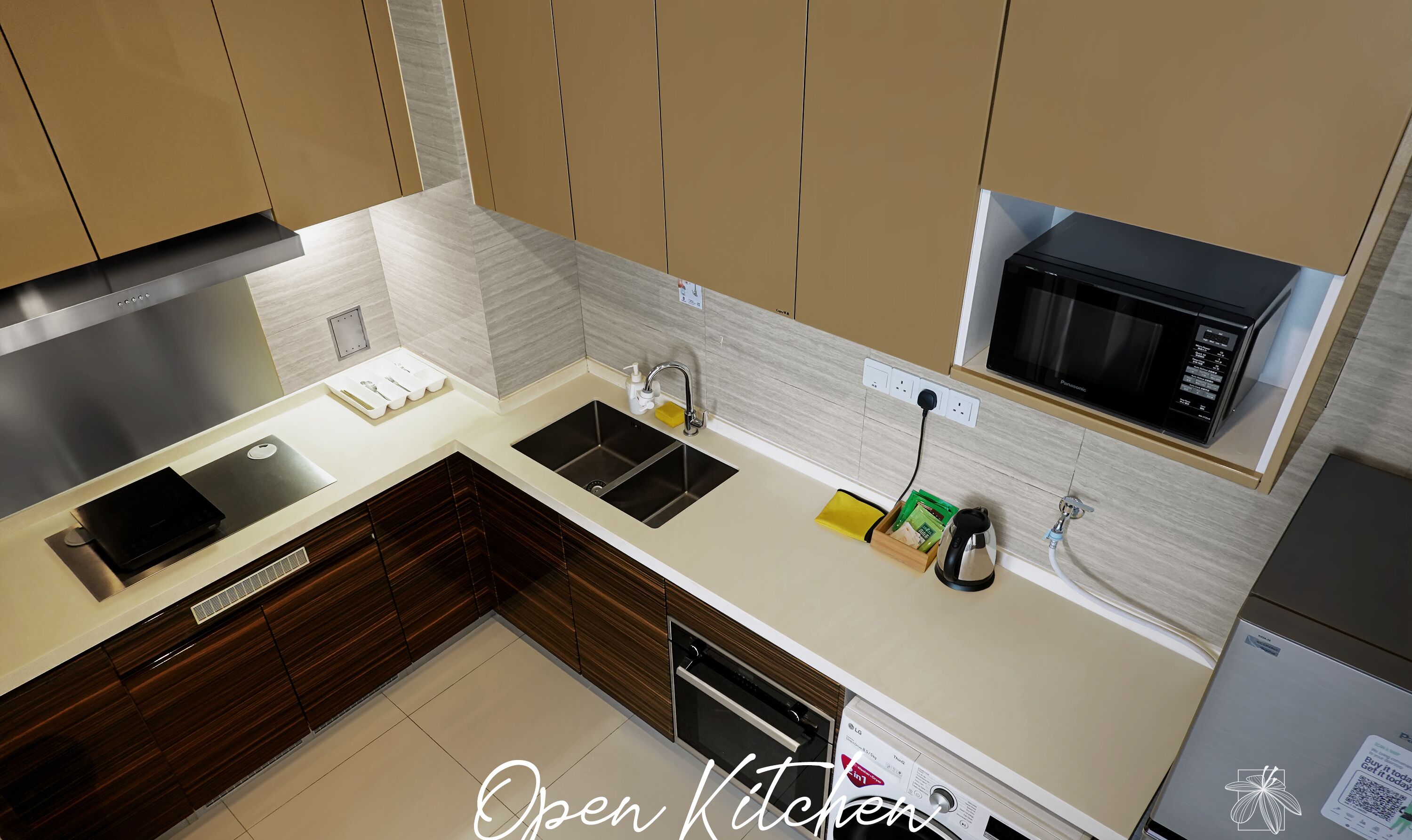 A modern kitchen with a built-in microwave, stainless steel sink, and wooden cabinets.