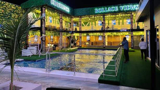 A hotel with a pool area, multiple levels, and a sign reading "Experience Rollace Views". - Rollace Hotel Lagos INTL (Lagos)