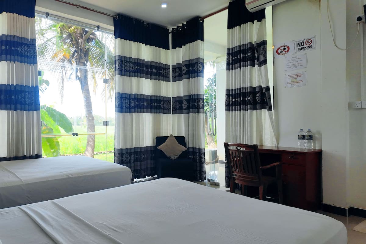 Deluxe Quadruple Room, 2 Queen Beds, Balcony, Garden View | Premium bedding, laptop workspace, soundproofing, iron/ironing board