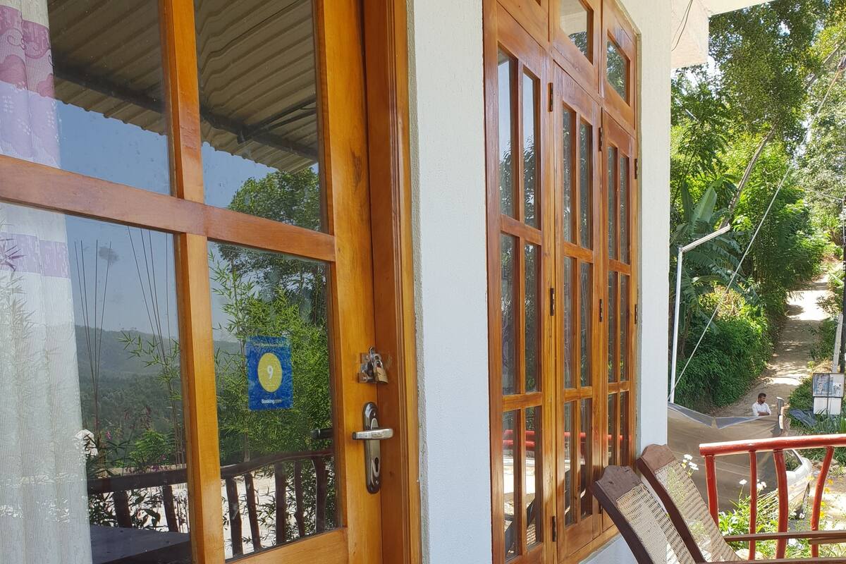 A wooden door with glass panels, a metal handle, and a keyhole.