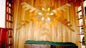 A room with a wooden wall design, a green cushioned bench, and a ladder on the left. - Prime Mt. Hood/Government Camp Loop Condo Background Beautiful 11,230 ft Mt Hood (Government Camp)