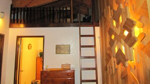 A room with a wooden ceiling, a ladder, a dresser, and a wall with geometric patterns. - Prime Mt. Hood/Government Camp Loop Condo Background Beautiful 11,230 ft Mt Hood (Government Camp)