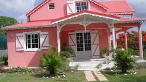 A pink house with a white porch and a red roof. - A Deshaies F5 sea view equipped for families / groups nearby beaches   (DESHAIES)