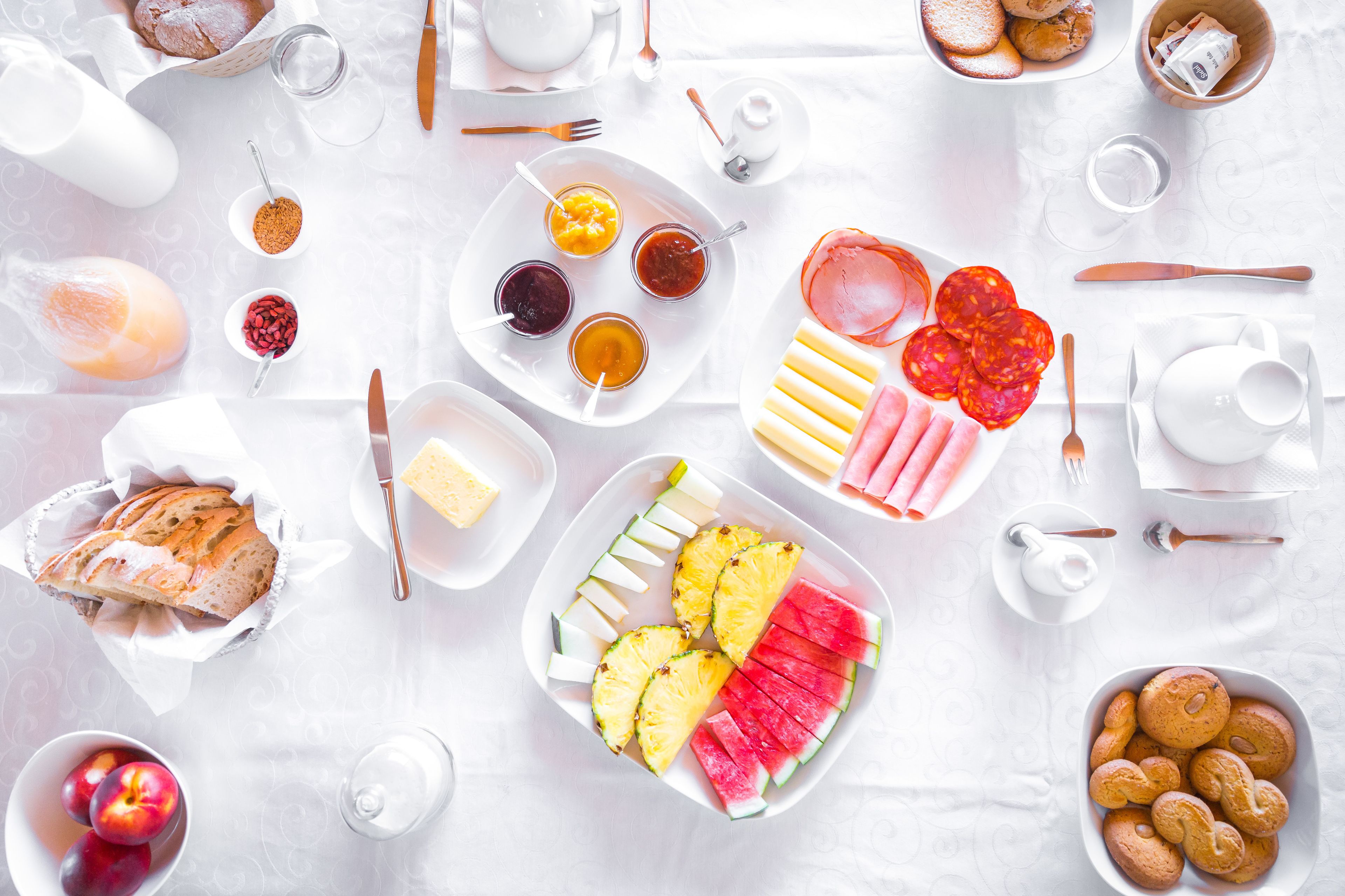 A breakfast spread with various foods and drinks on a table.
