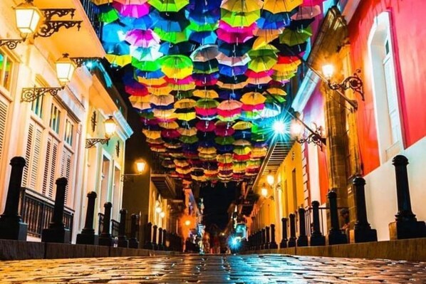 A cobblestone street with colorful umbrellas hanging overhead. - CONDO HOTEL, DORADO (WITH LIVING ROOM/ DINNING ROOM / KITCHEN) (Higuillar)