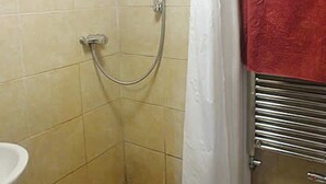 A small bathroom with a shower, a toilet, and a sink. - Keepers Cottage - sleeps 2 adults, 2 children and your dogs (Cornwall)