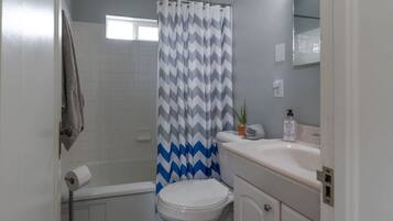 Bathtub, hair dryer, towels, soap