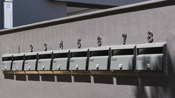 A row of mailboxes numbered 1 to 8 against a wall.