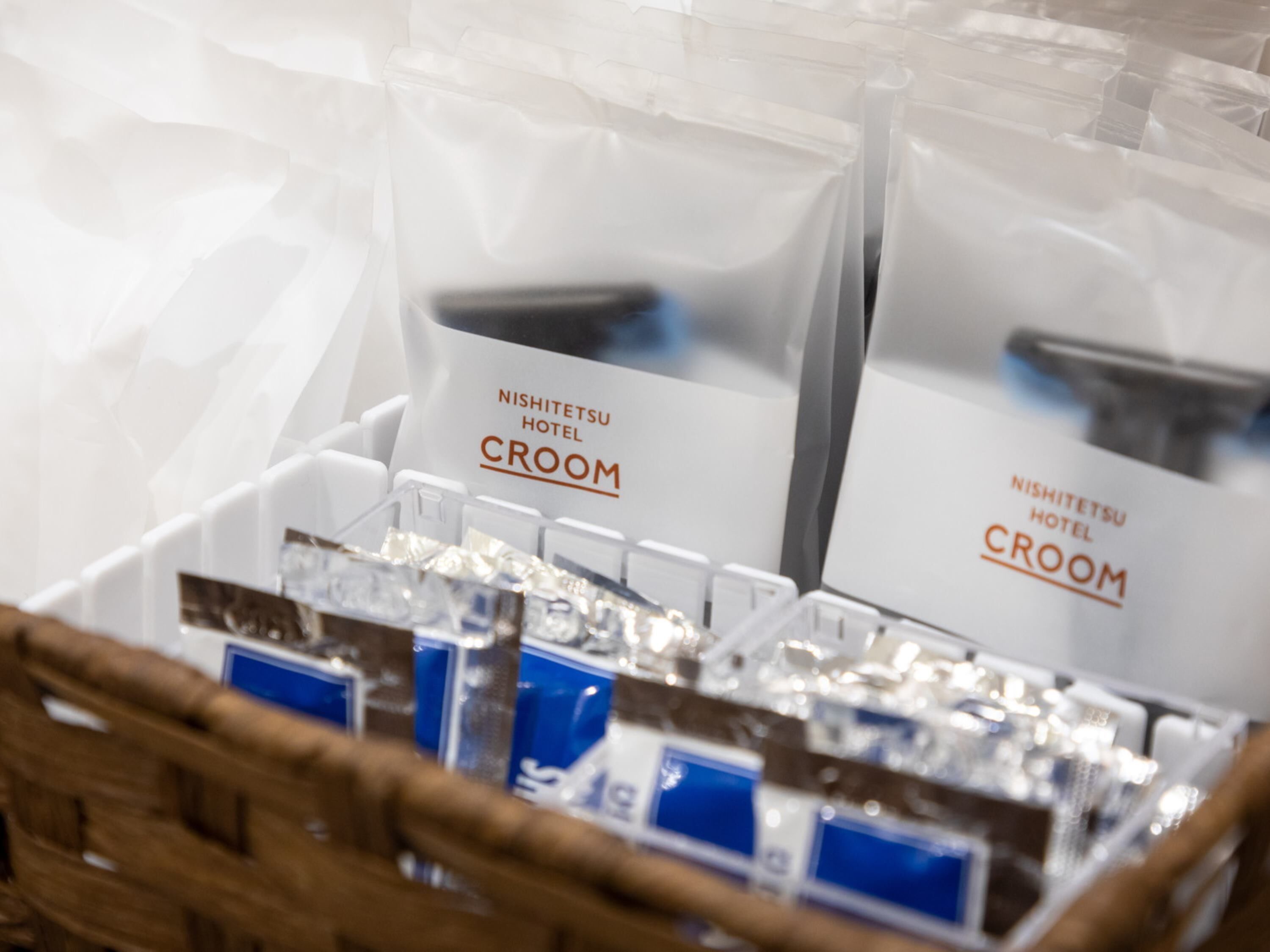 A display of toiletries in clear plastic containers with labels reading "Nishitetsu Hotel CREAM".