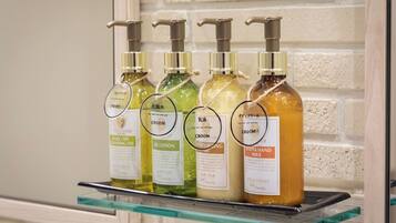 A shelf with four bottles of body care products.