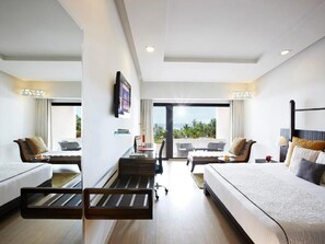 A hotel room with two beds, a desk, a chair, and a balcony with a view. - Gateway Varkala - Ihcl Seleqtions (Varkala)