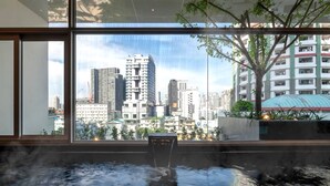 A modern interior with a large window overlooking a cityscape. - Jasmine 59 Hotel Thonglor Bangkok (Bangkok)