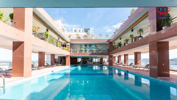 Una piscina con vista a un edificio al fondo.