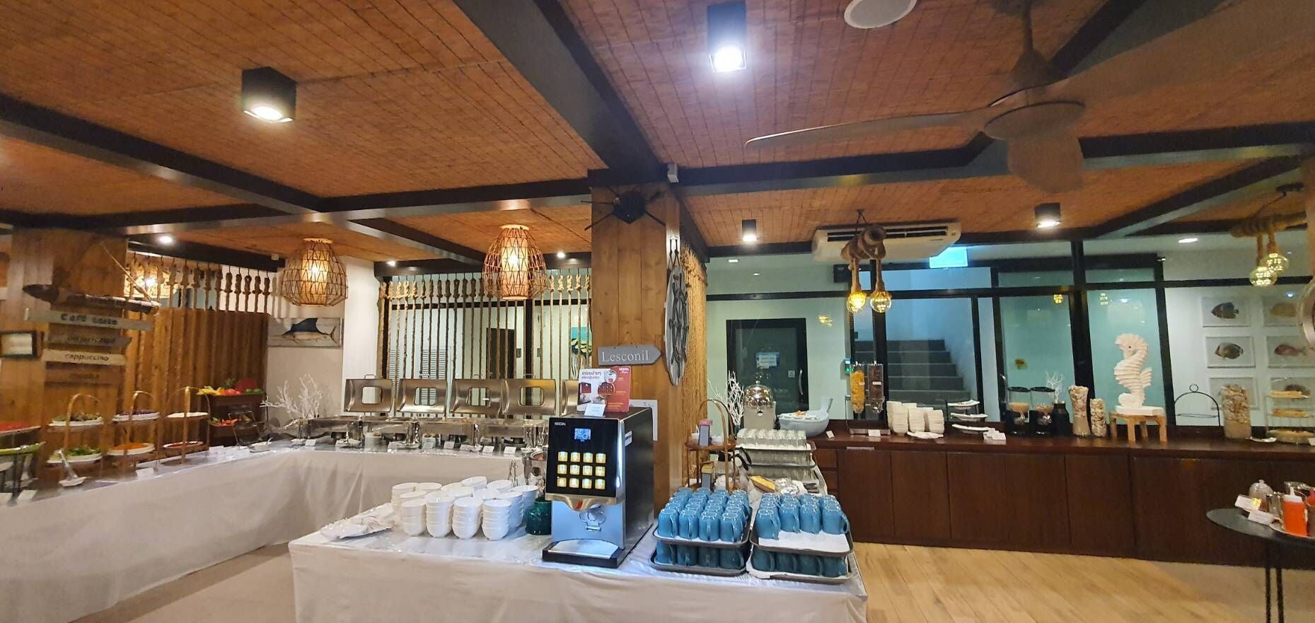 A buffet setup with various food items and a coffee station.