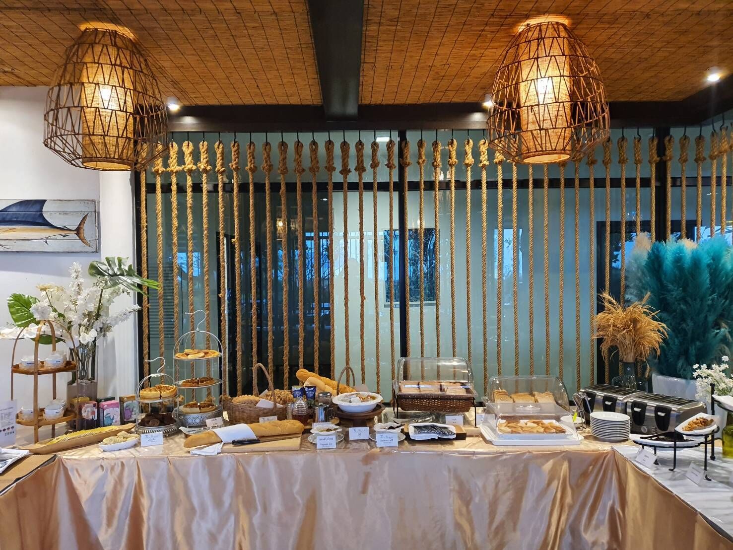 A buffet setup with various food items and a decorative backdrop.