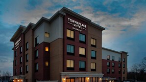 A multi-story TownePlace Suites Marriott hotel with a brick facade, large windows, and a parking lot. - TownePlace Suites by Marriott College Park (College Park)