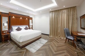 Relax in comfort with a large bed, desk, and window offering a view.