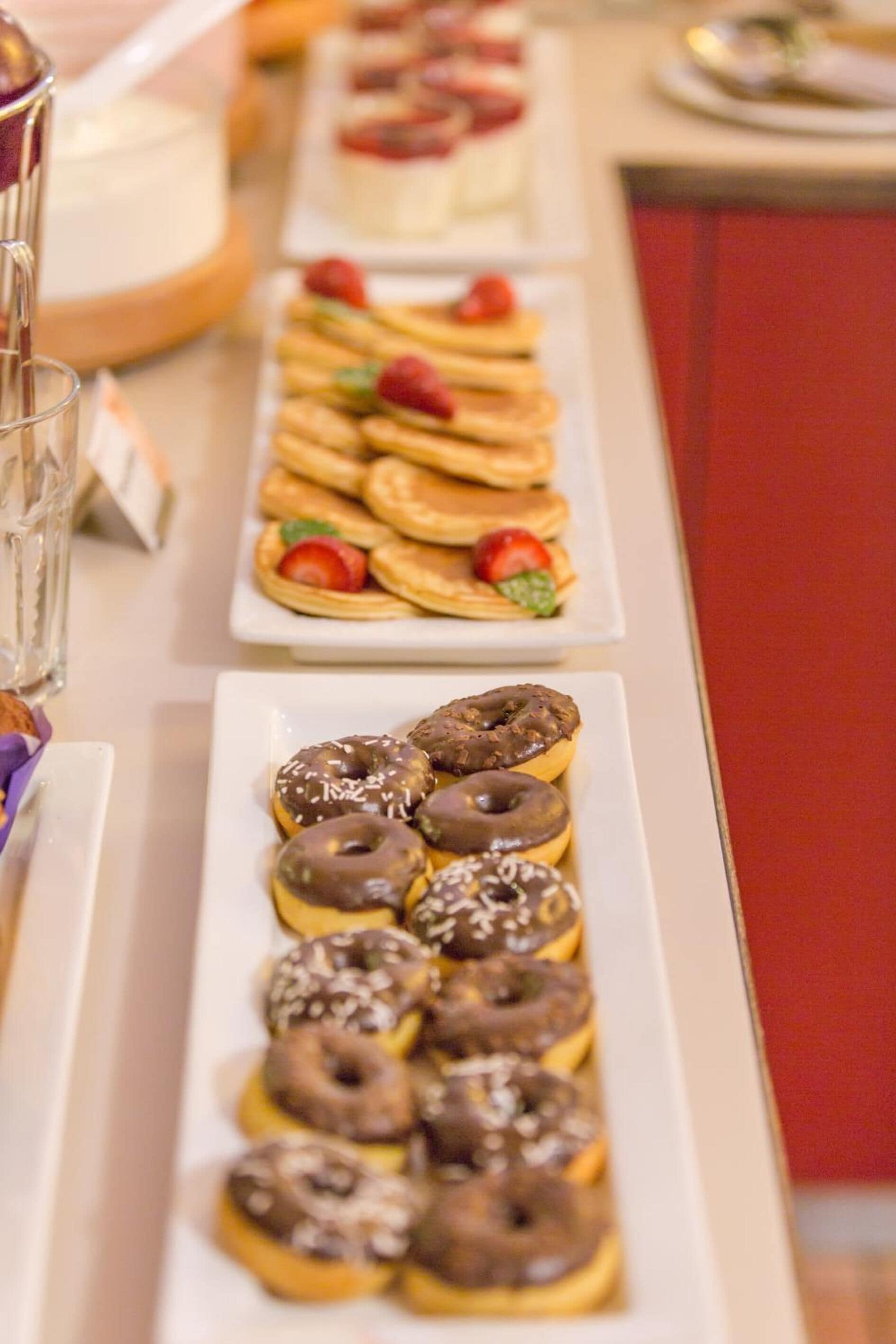 A buffet table with various pastries and desserts.