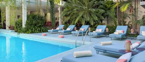 A poolside area with lounge chairs and a swimming pool.