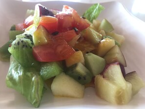 A fruit salad with various fruits and a white plate. - Sunrise235 (Zhuqi)