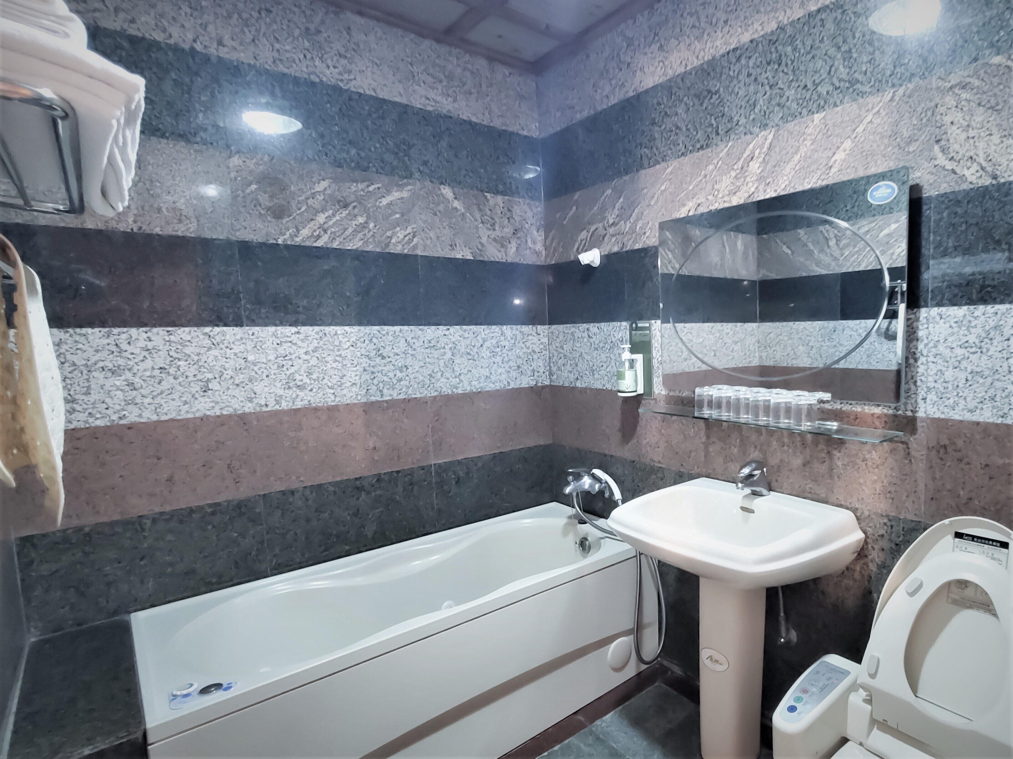A modern bathroom with a bathtub, a sink, and a toilet.