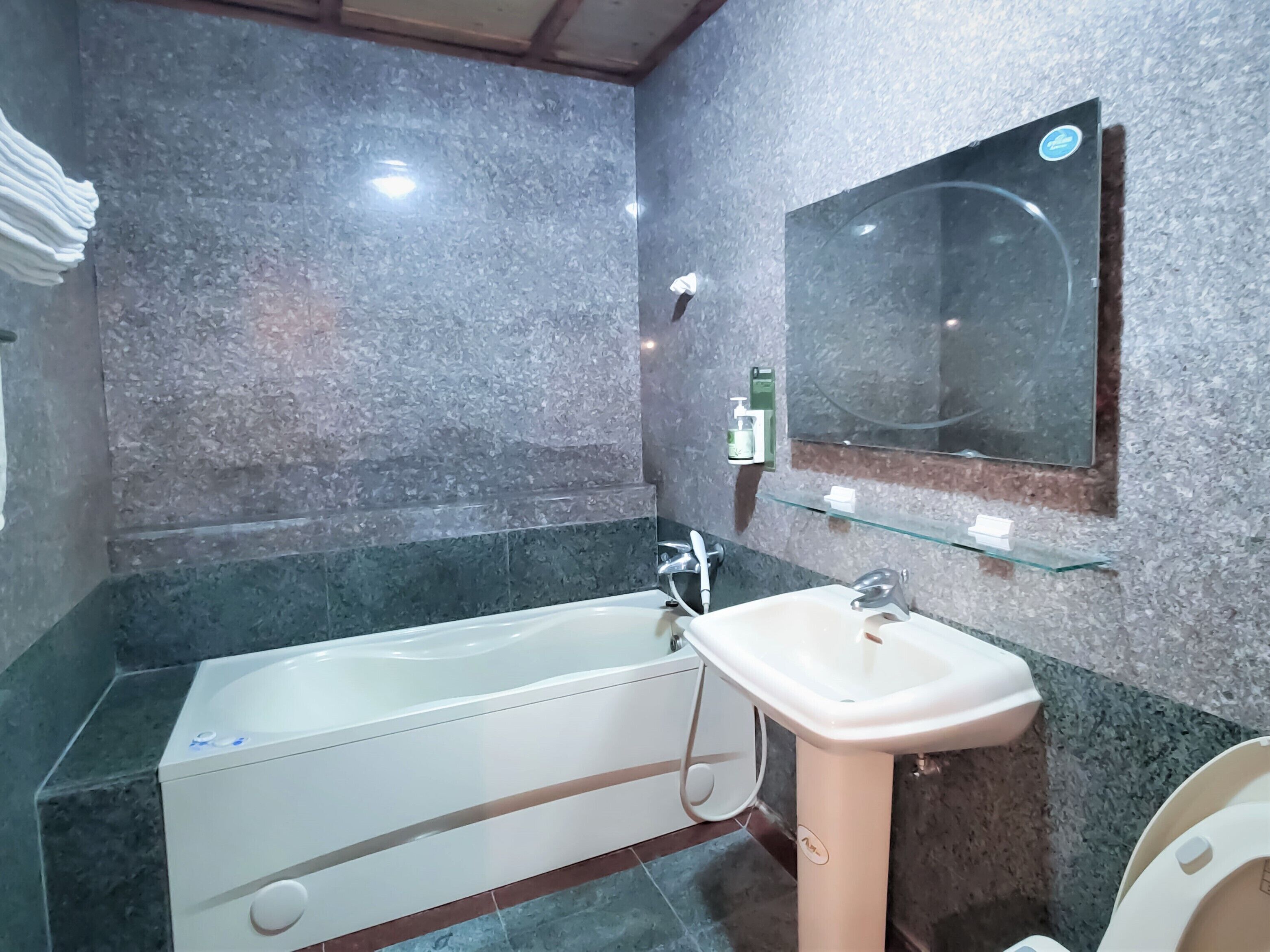 A bathroom with a bathtub, a sink, and a toilet.