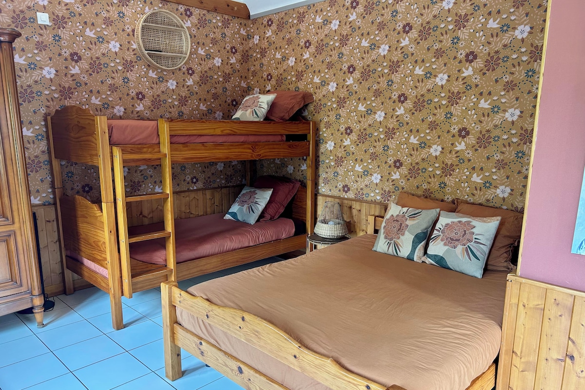 A bunk bed with a wooden frame and a single bed with a wooden headboard.