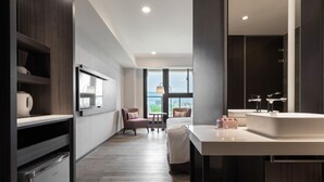 A modern hotel room with a large window, a dining area, and a kitchenette. - Lakeshore Hotel Yilan (Yilan)