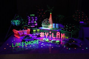 A neon-lit display with the text "#YILAN" and "LAKESHORE" prominently featured.