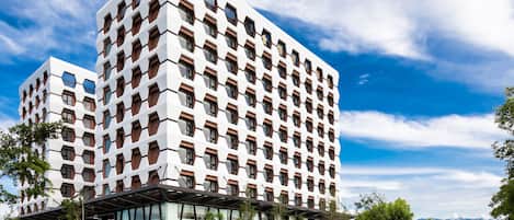 Stylish hotel building with a unique architectural design, featuring rectangular windows and a flat roof.