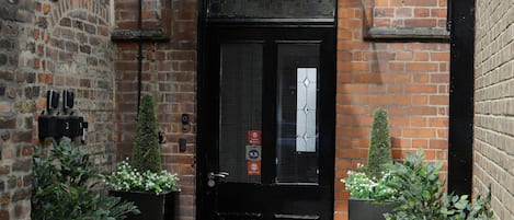 A brick building with a sign reading "Village Hotel Entrance."