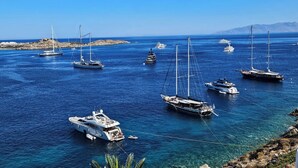 A marina with various sailboats and yachts anchored in clear blue waters. - Mykonos Azure (Mykonos)