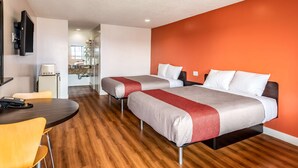 A hotel room with two beds, a dining area, and a kitchenette. - Motel 6 Gardena, CA - South (Gardena)