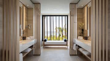 Enjoy a serene bathroom experience with a central bench and two large mirrors offering a view of the outdoors.