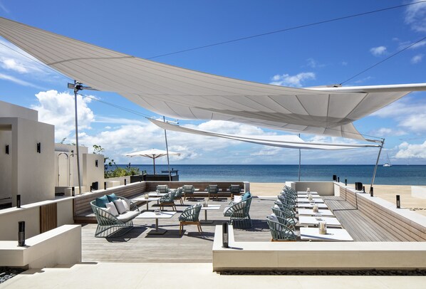 A rooftop terrace with outdoor seating, a view of the ocean, and a clear sky. - Silversands Grand Anse (St. George's)