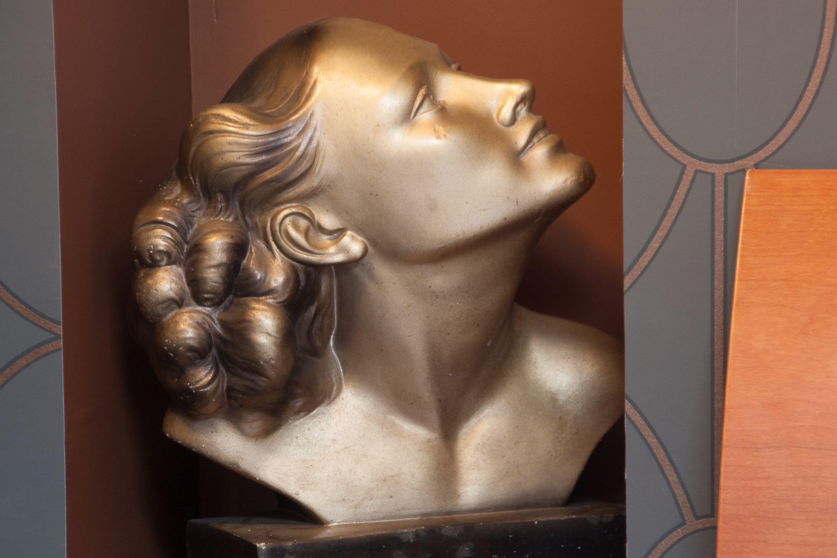 A bust sculpture with intricate hair details.