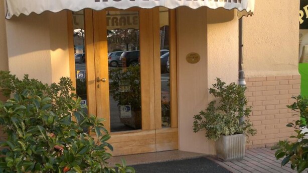 A hotel entrance with a white awning and the name "HOTEL CENTRALE" displayed. There are potted plants in front of the entrance. - Hotel Centrale (Argenta)