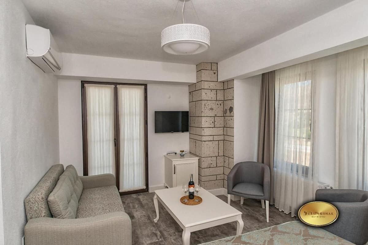 deluxe room, balcony | living room | 32-inch lcd tv with satellite channels, tv