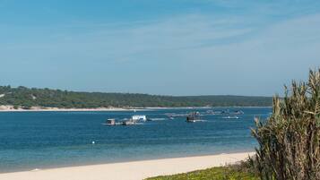 Beach nearby, white sand, beach umbrellas, beach towels