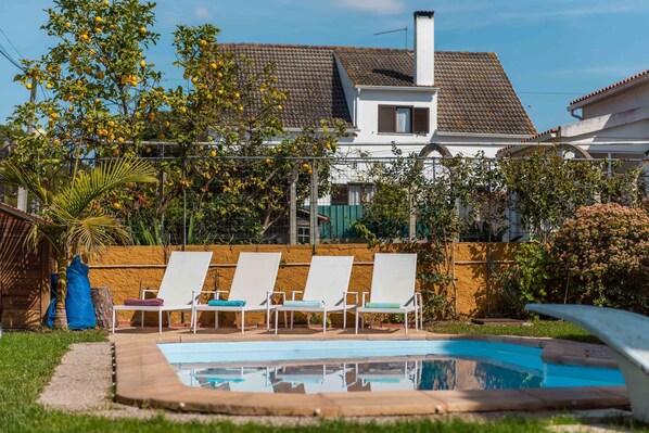 Seasonal outdoor pool, pool umbrellas, pool loungers