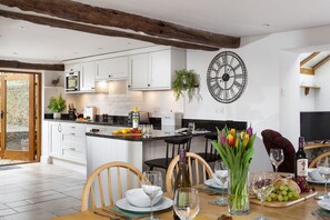 Enjoy cooking in this well-lit kitchen with a central island, oven, and microwave, plus ample dining space.