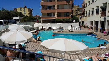 Seasonal outdoor pool, open 9:00 AM to 6:00 PM, pool umbrellas