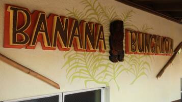 A wall with the text "BANANA BUNGALOW" and a decorative plant design.