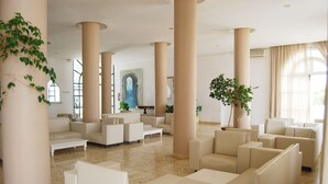 A spacious lobby with high ceilings, large columns, and multiple seating areas. - Hôtel El Andalous (Soliman)