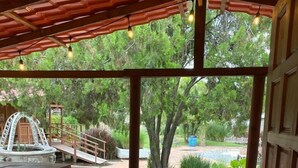 A wooden deck with a covered area, a small bridge, and a pool in the background. - Roca Azul (Jocotepec)
