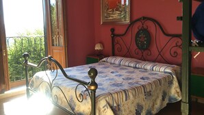 A bedroom with a bed, a window, a painting, and a balcony. - Bed & Breakfast Ristorante Belvedere (Subiaco)
