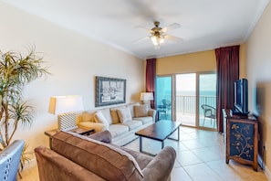 Relax in this stylish living room with a comfortable sofa, armchair, and coffee table, perfect for unwinding with a view of the outdoors.