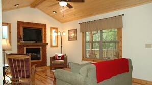 A cozy living room with a fireplace, a television, and a comfortable seating area.