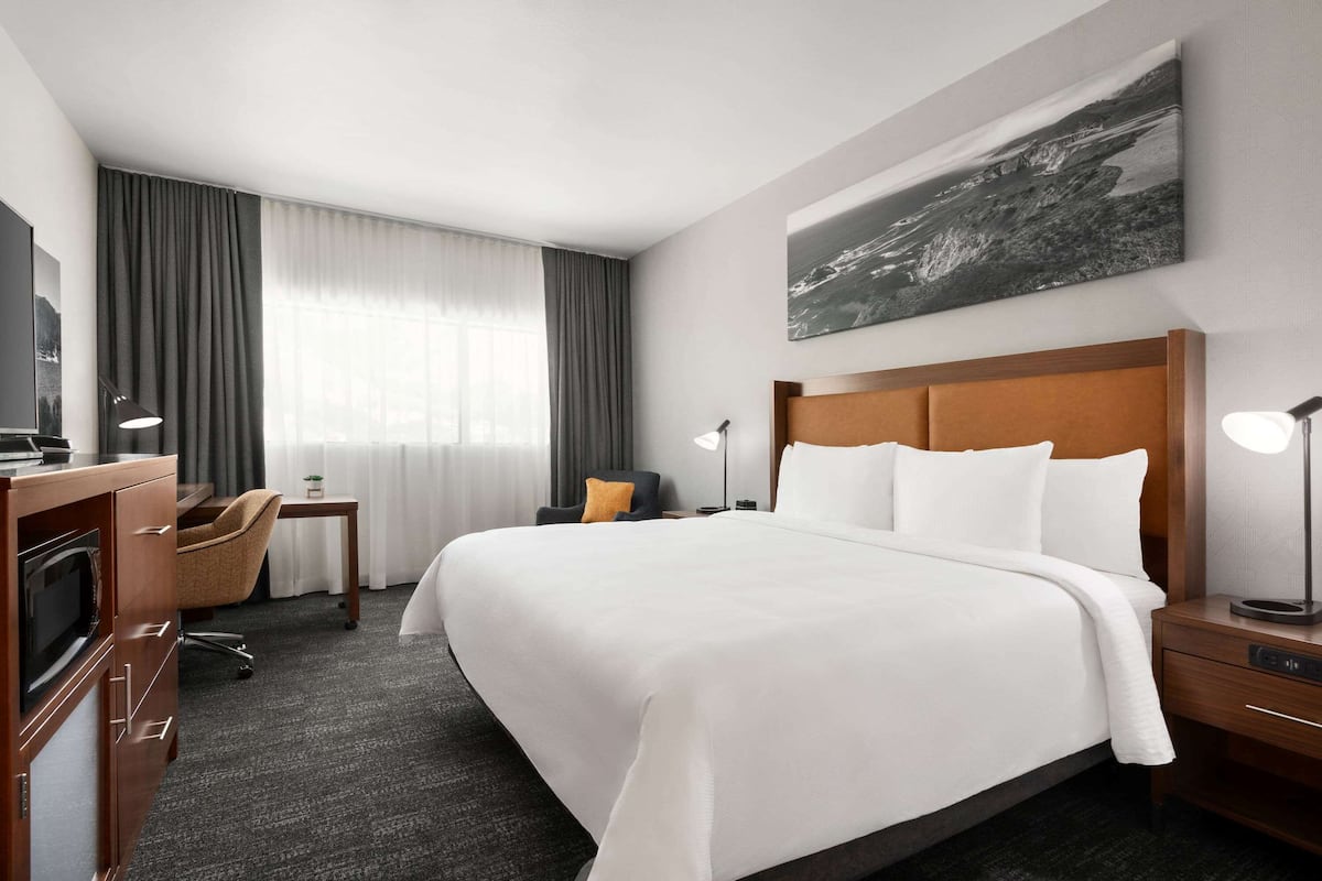 Premium bedding, desk, laptop workspace, iron/ironing board
